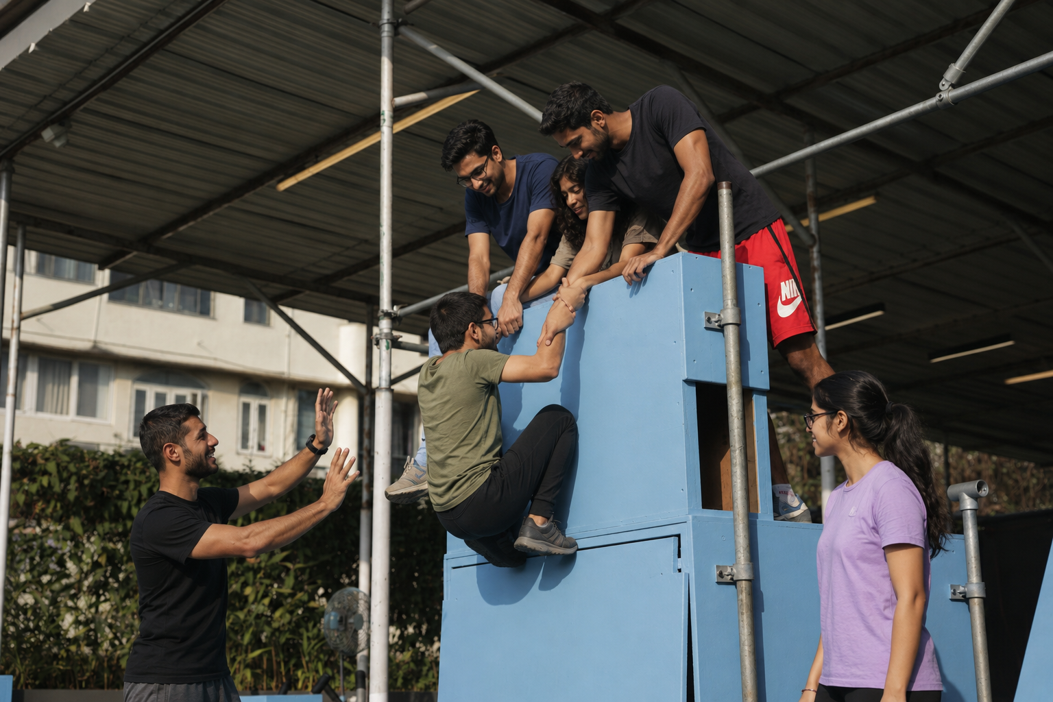 Academy teammates helping one another during a climbing exercise