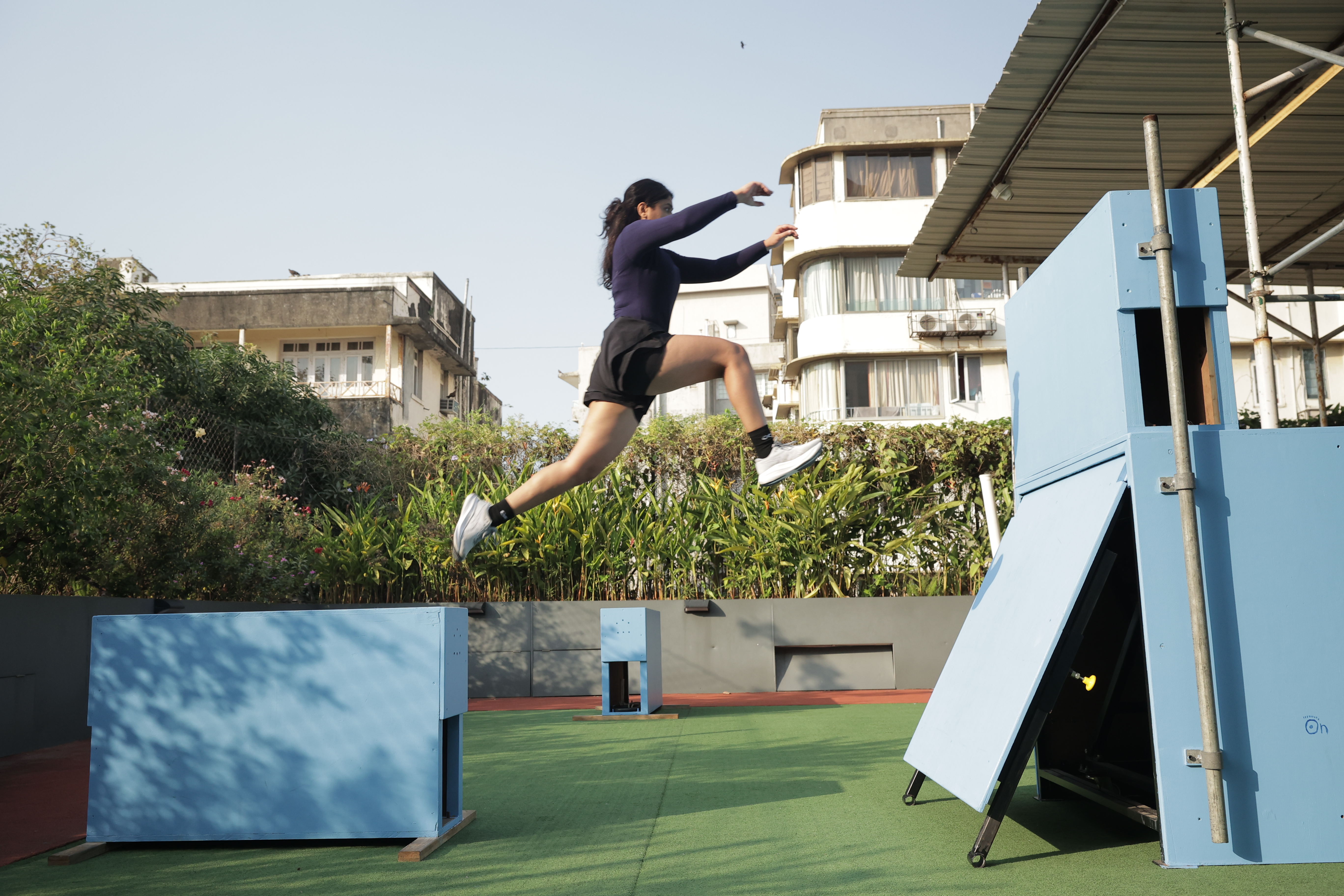 An adult athlete training a jump at the academy